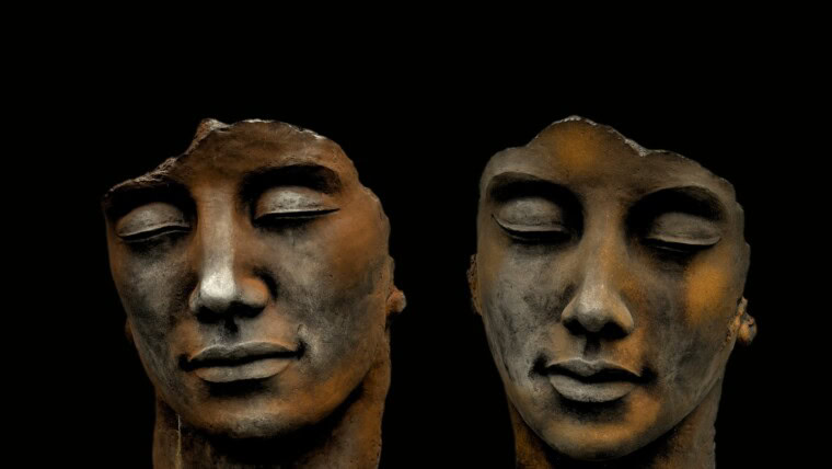 mans face carved on black surface