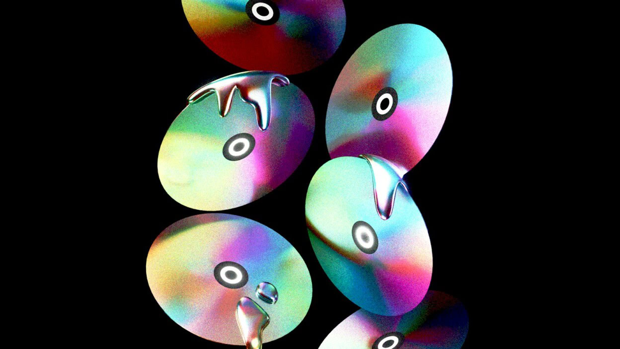Abstract colorful cds are floating in the dark.