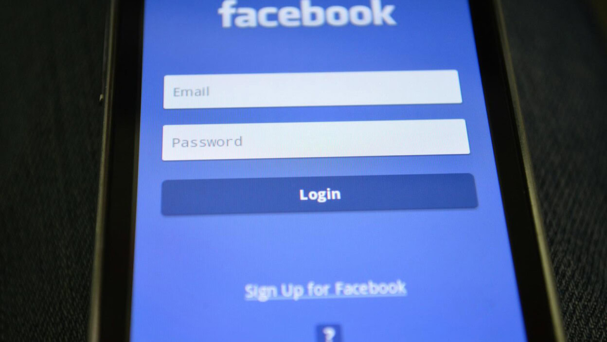 Close-up of a smartphone screen showing the Facebook login interface.