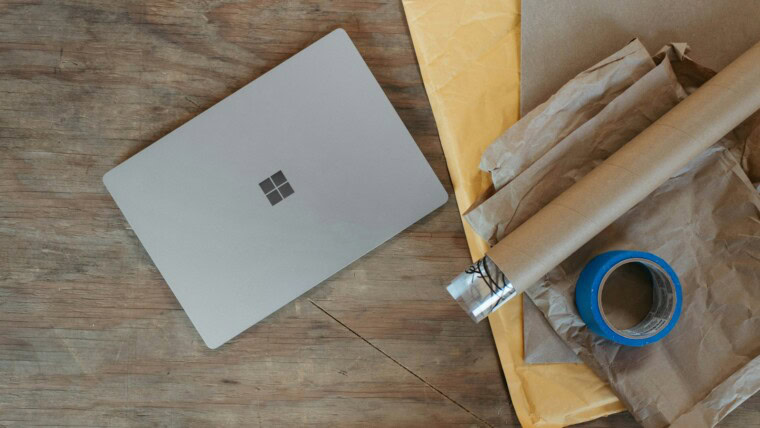 a laptop computer sitting on top of a wooden table