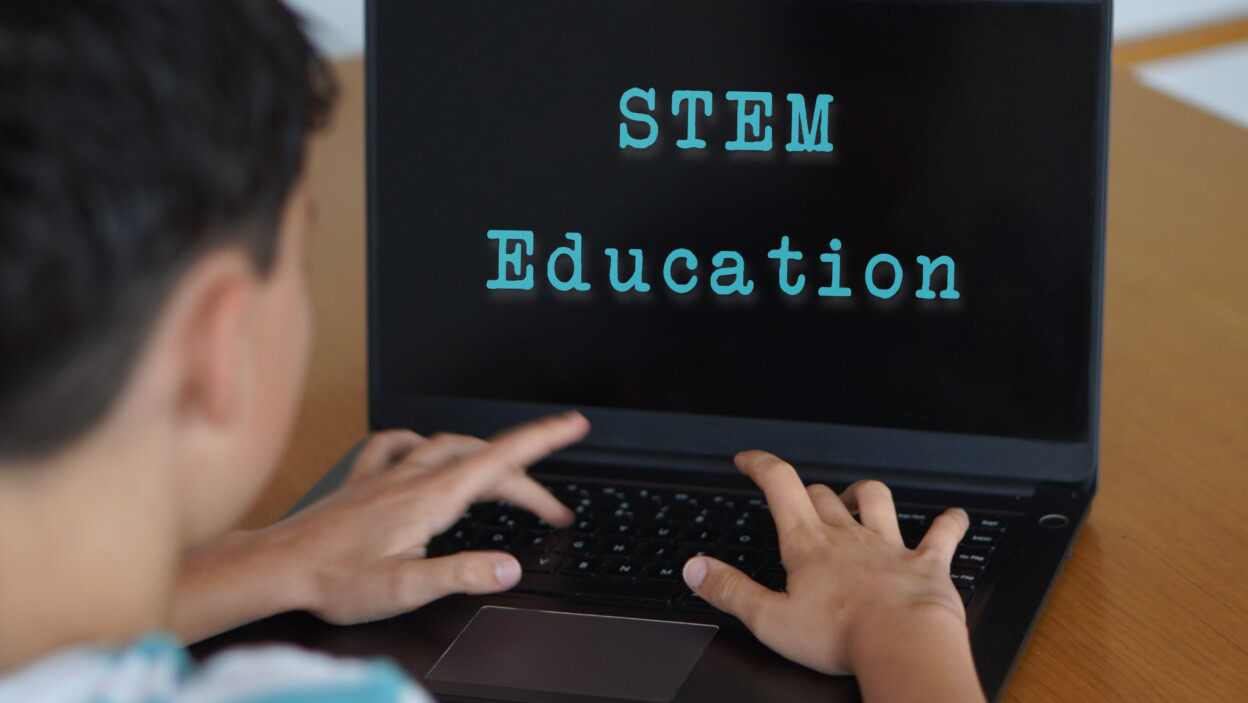 Child engaged in STEM Education on a laptop
