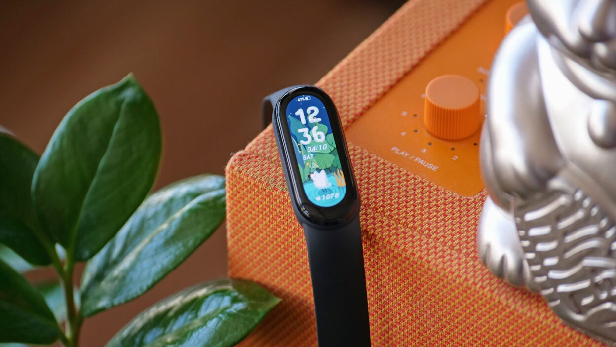 black and silver apple watch with orange strap