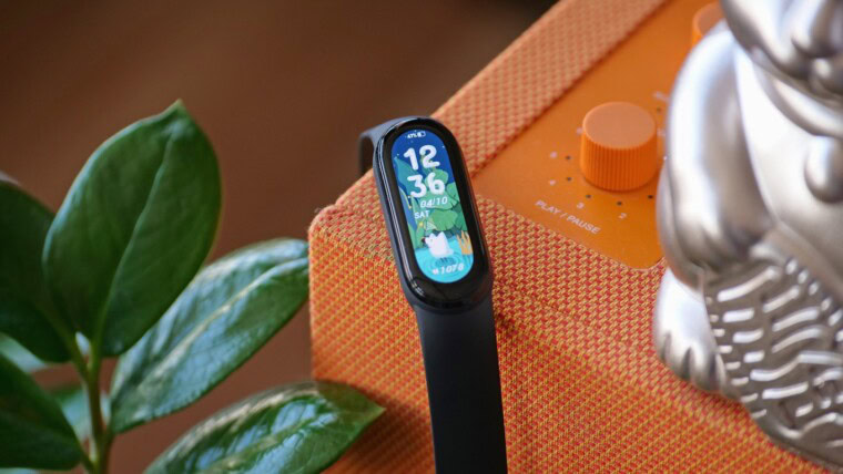 black and silver apple watch with orange strap