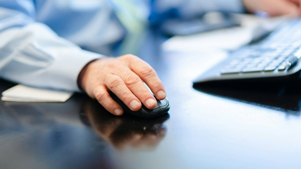 a man is typing on a computer keyboard