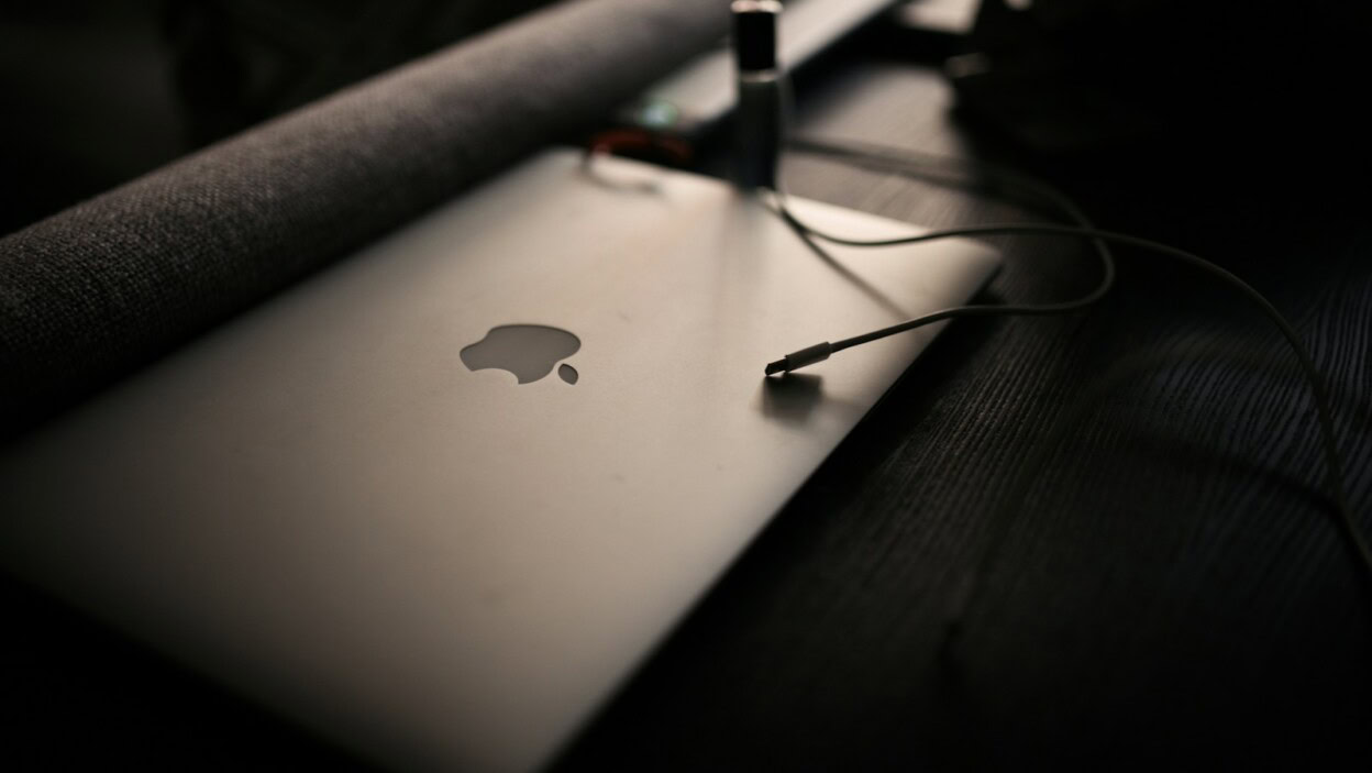 macbook pro on brown wooden table