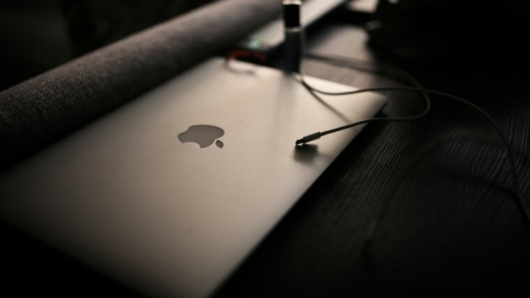 macbook pro on brown wooden table